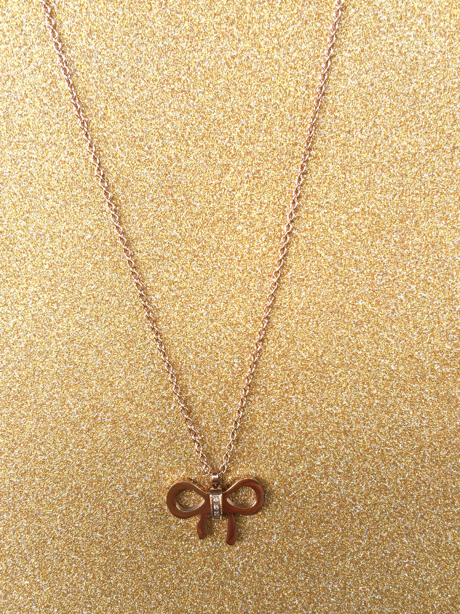 A beautiful butterfly pendant made of mother of pearl and emblazoned with small glittering crystals on a gold metal base. J020010